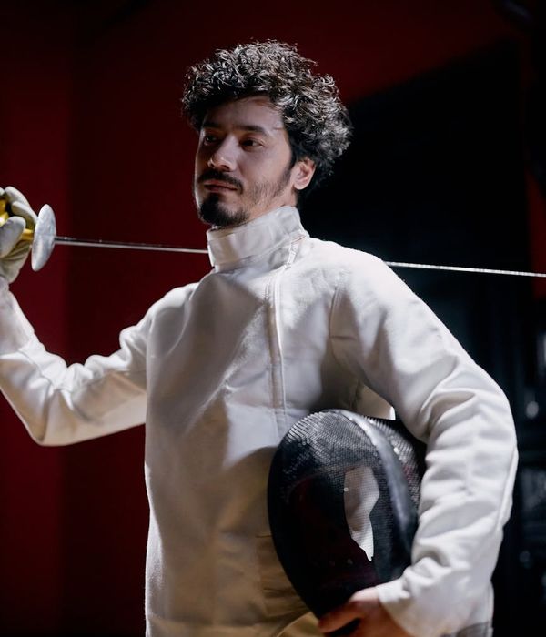 Man holding a difficult balance pose, showing focus and stability.